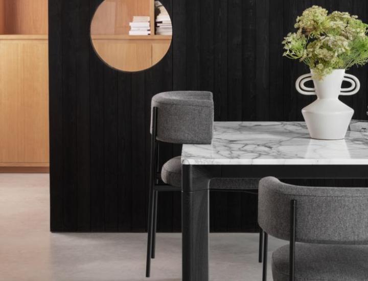 Chaise visiteur gamme AMELIE de la marque MIDJ, pietement droit aluminium, assise et dossier rembourrées, chaise posée sur le plan de travail, pour faciliter le nettoyage du sol dans un espace sombre type salle à manger